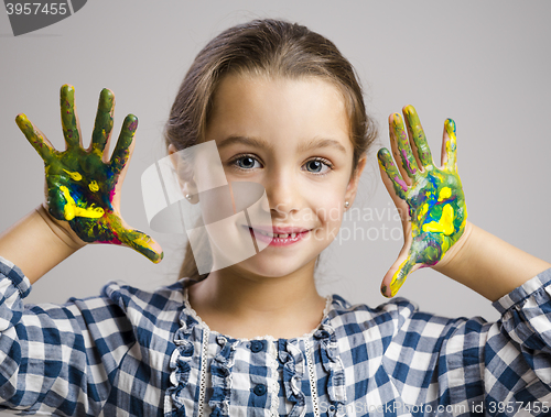 Image of Little girl with hands in paint