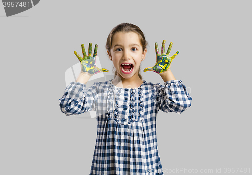 Image of Little girl with hands in paint