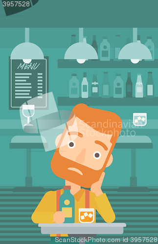 Image of Sad man with bottle and glass.