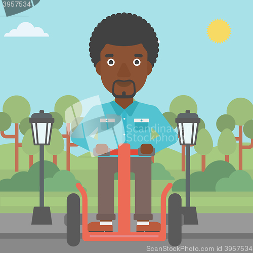 Image of Man riding on electric scooter.