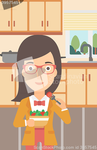 Image of Woman eating salad.