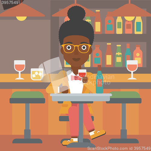 Image of Woman sitting at bar.