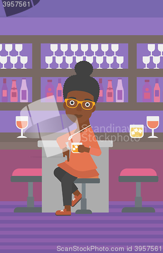 Image of Woman sitting at bar.