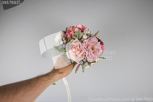 Image of male hand giving wedding bouquet