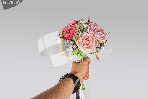 Image of male hand giving wedding bouquet