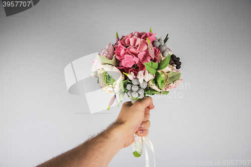 Image of male hand giving wedding bouquet