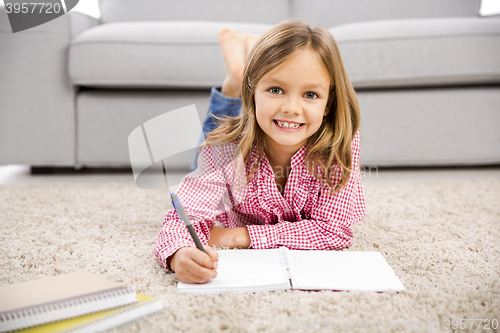 Image of Little girl making homework