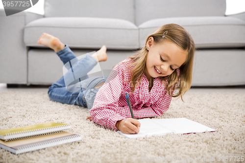 Image of Little girl making homework