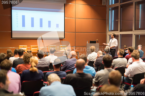 Image of Business speaker giving a talk in conference hall.