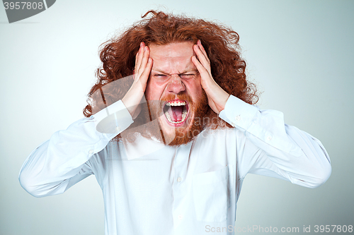 Image of Stressed businessman with a headache