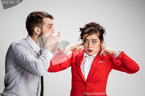 Image of The business man and woman communicating on a gray background