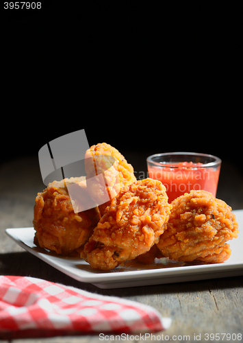 Image of fried chicken drumstick and ketchup