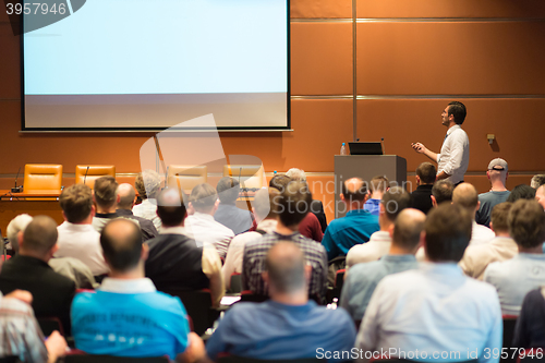 Image of Business speaker giving a talk in conference hall.