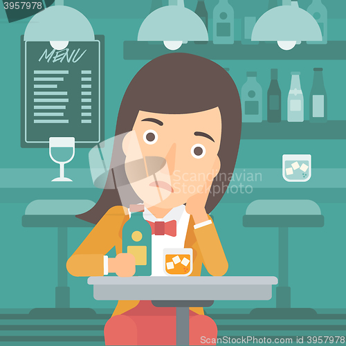 Image of Sad woman with bottle and glass.