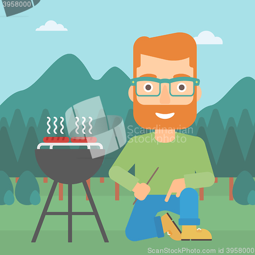 Image of Man preparing barbecue.