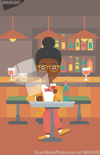 Image of Woman sitting at bar.