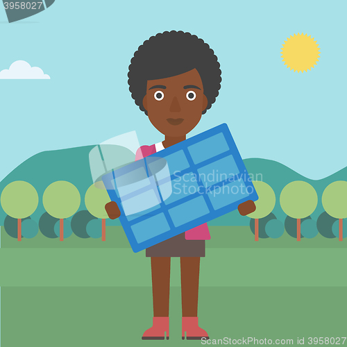 Image of Woman holding solar panel.