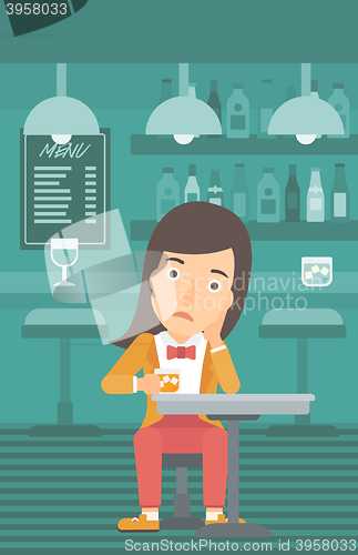 Image of Woman sitting at bar.