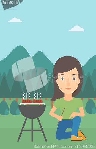 Image of Woman preparing barbecue.