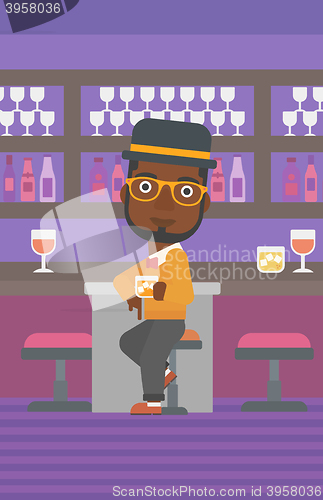 Image of Man sitting at bar.