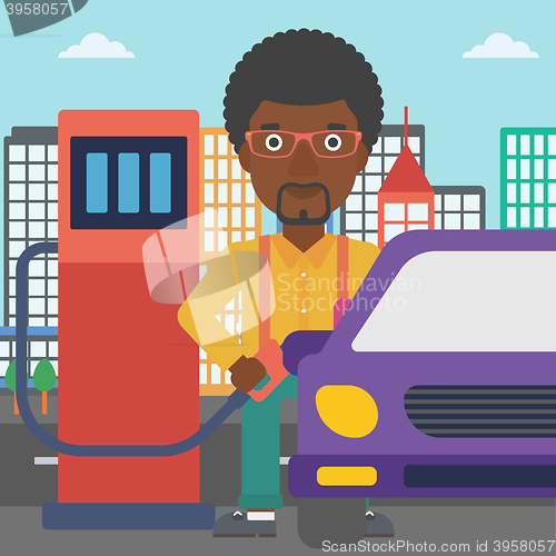 Image of Man filling up fuel into car.