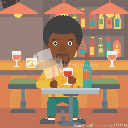 Image of Man sitting at bar.