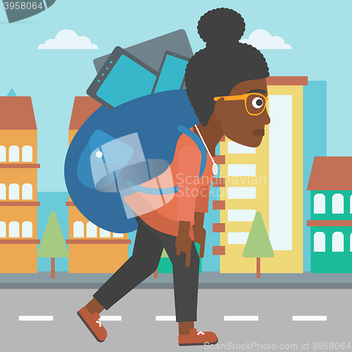 Image of Woman with backpack full of devices.