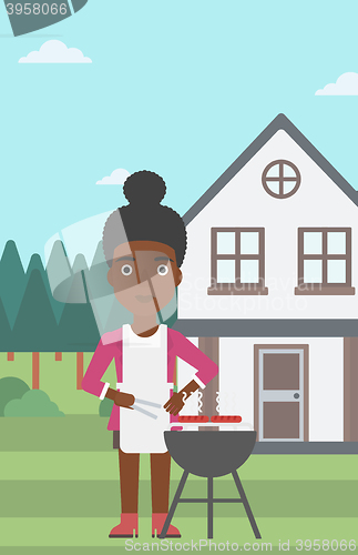 Image of Woman preparing barbecue.