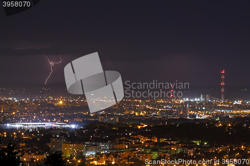 Image of Lightning storm over city at night