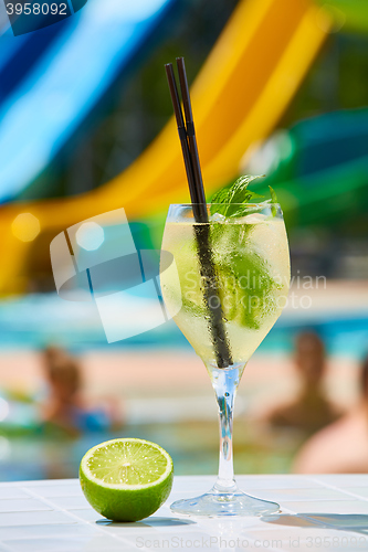 Image of Close up Cocktail margaritas with lime near the swimming pool