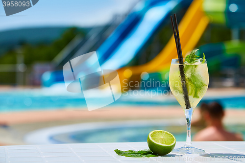 Image of Close up Cocktail margaritas with lime near the swimming pool