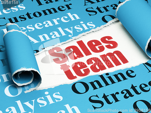 Image of Advertising concept: red text Sales Team under the piece of  torn paper