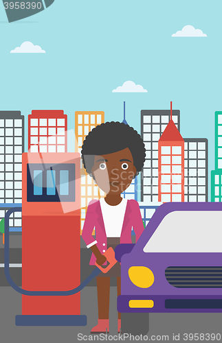 Image of Woman filling up fuel into car.