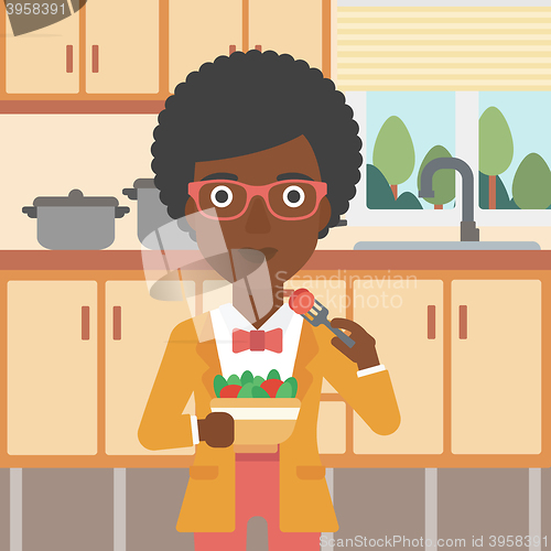 Image of Woman eating salad.