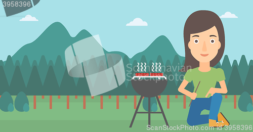 Image of Woman preparing barbecue.