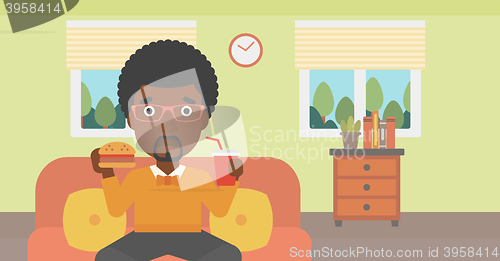 Image of Man eating hamburger. 