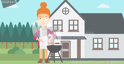 Image of Woman preparing barbecue.