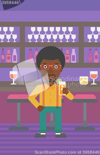 Image of Man holding glass of juice.