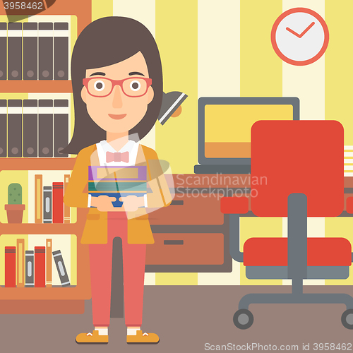 Image of Woman holding pile of books.