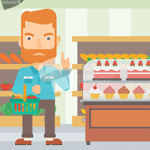 Image of Man holding supermarket basket.