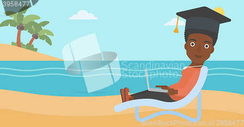 Image of Graduate lying on chaise lounge with laptop.