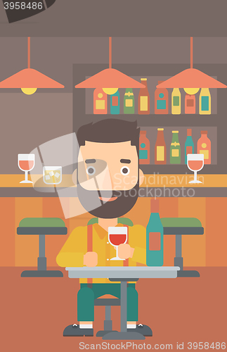 Image of Man sitting at bar.