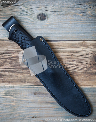 Image of hunting knife in a leather scabbard