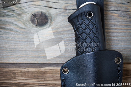 Image of part of hunting knife in a leather scabbard