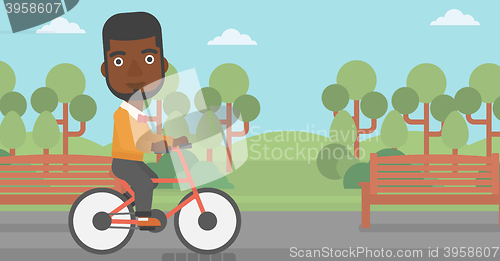 Image of Man riding bicycle.