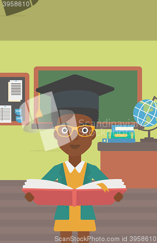 Image of Woman in graduation cap holding book.