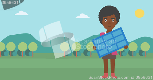 Image of Woman holding solar panel.