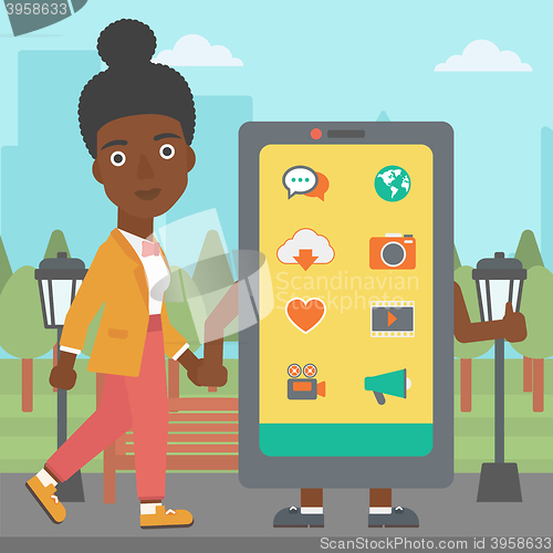 Image of Woman walking with smartphone.
