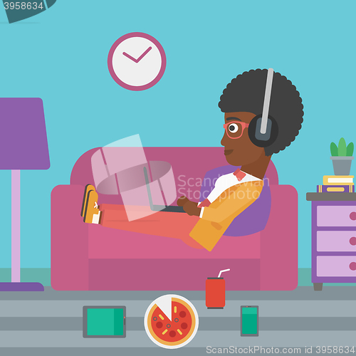 Image of Woman lying on sofa with many gadgets.