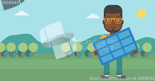 Image of Man holding solar panel.